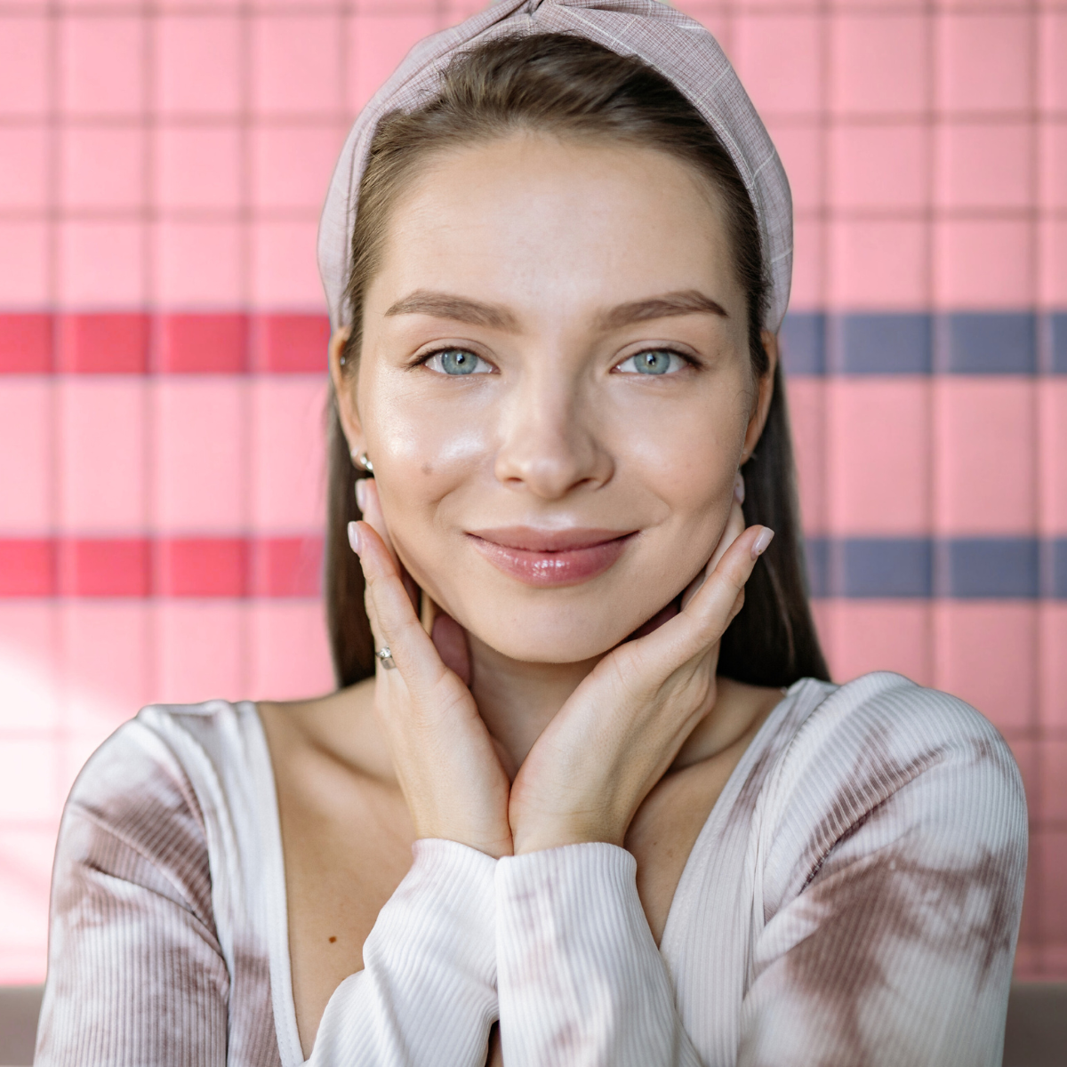 woman applying sunscreen as part of daily skincare routine for sagging jowls