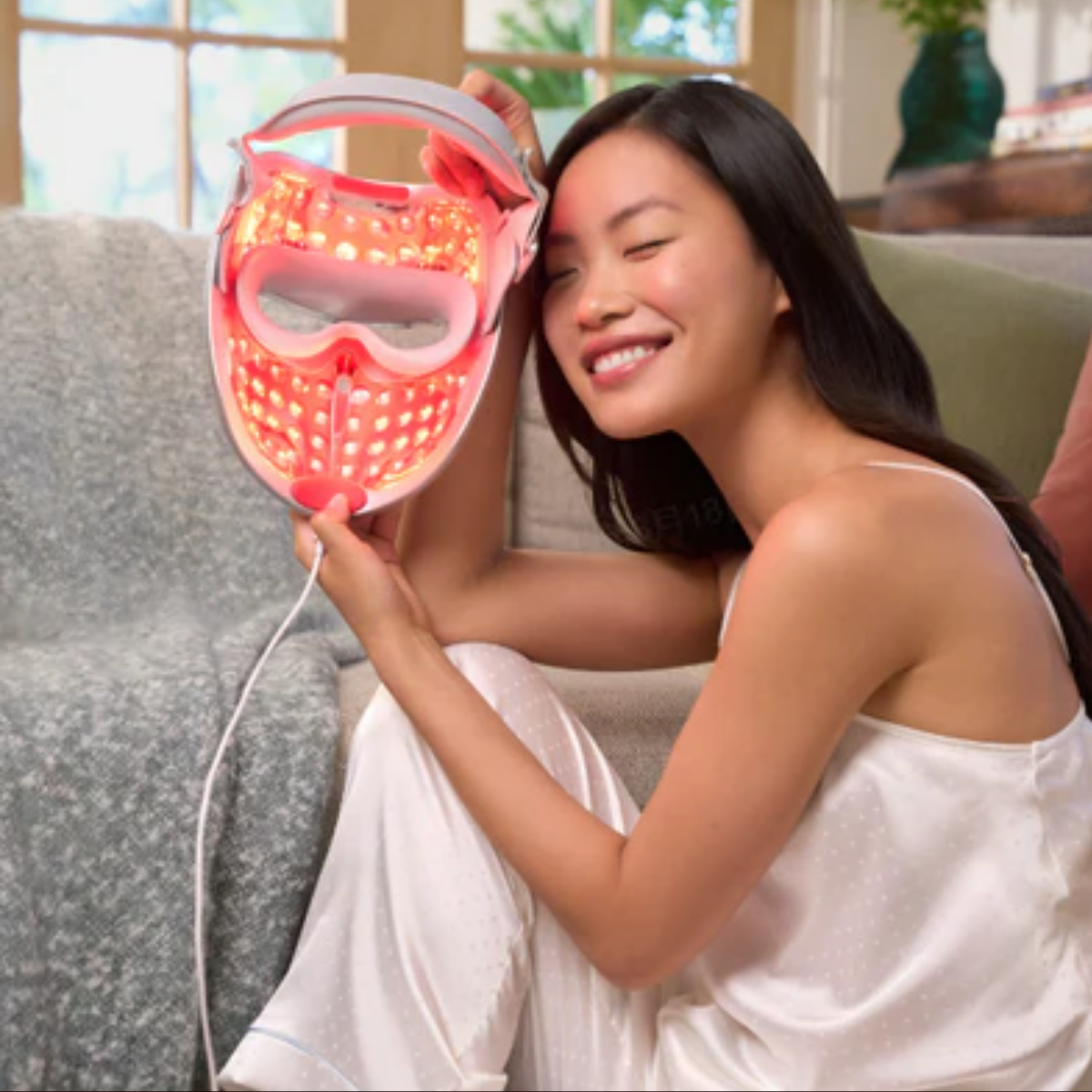 Person wearing an LED face mask at home as part of a UK skincare routine