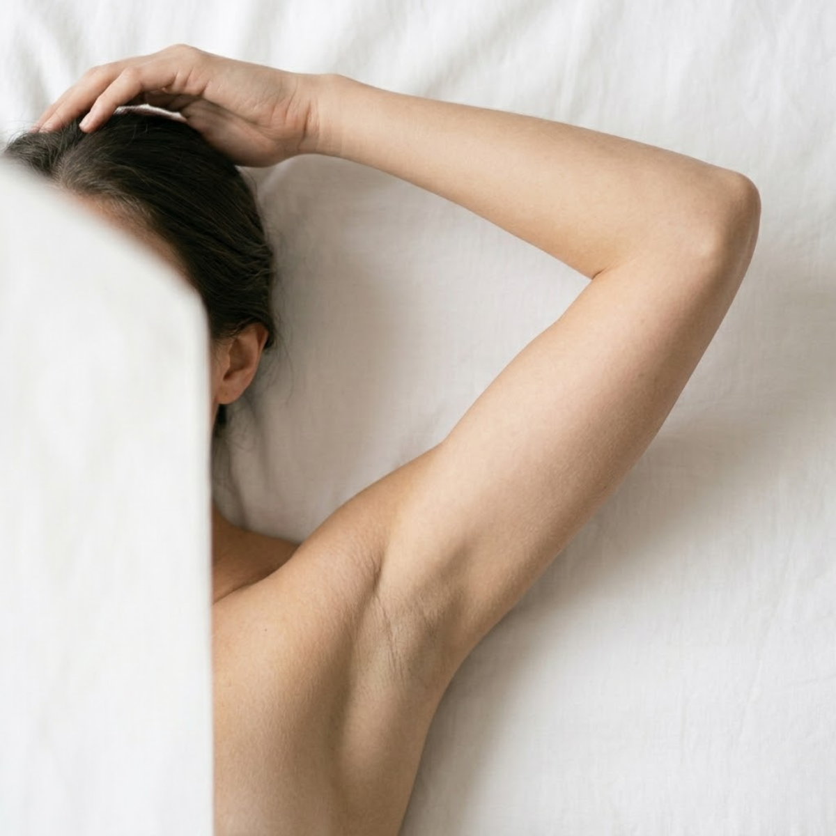 Woman's raised arm with smooth underarm skin, featured image for guide on ingrown hairs in the armpit